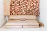 The first rug designed between Casa Milana and Beni, shown here in white, covered the floor. A star of the current collection hung above it, demonstrating the graphic inspiration the teams gained from the terrazzo underfoot.