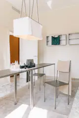 Tucked into a small room in Convey’s venue, Rooms Studio spotlit a few of their offerings, from sleek chairs to angular chess sets to leather draping on pendant lights and shelving.