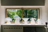 OOG Objects’s milky glassware caught light coming through a small window.