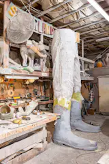The interior of Enchanted Castle Studios is shared by a workshop and a warehouse, where completed projects like dinosaurs and miniature trains stand alongside molds for unique sculptures Cline has restored over the years.