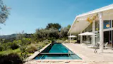 The shaded porch is 12 feet deep, with views of the rolling Topanga hills.