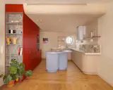 The color palette of the home is largely neutral, based on Royal Flax by Benjamin Moore. The interior of the red storage units is covered in a veneer Ettore Sottsass designed for ALPI.