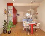 A pastry chef and a perfusionist splurged on bespoke cabinetry and fluted glass to fill their run-down Barcelona flat with light, color, and curves.
