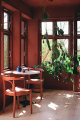 The home’s entry is a sunroom with a seating area.