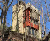 The four-story “Ivory Tower” that overlooks the property was built in 1964 as a writer’s office, guest house, and workroom. Connected to the carport and attached studio, it has been updated with a new roof, windows, doors, and interior framing, leaving the interior for the next owner to complete.