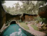 Down a few steps from the sauna is a lap pool that runs into a grotto, which connects with the guest house at the rear of the property.