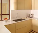 30 Years Later, They Reimagined Their Rome Apartment With a Glassy Central Kitchen