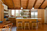 Minimalist wooden kitchen cabinets from Danish company Reform bring warmth to the space. The arabescato cremo marble counter was on clearance—there was just one large piece left.