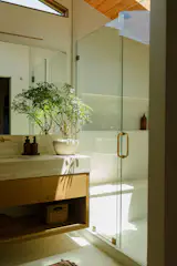 The plant from Printwood is a recent addition, and brought the room to life; the leaves glow in the sun that comes through the shower skylight.