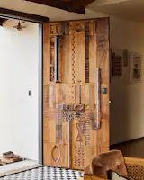 After seeing the wood carvings that his friend Matthew Wignall was doing, Joe asked if the artist would be interested in making a door. They gave him no direction, and it was the largest piece he had undertaken. The result is a showstopper of an entry that sets the tone for the house: original, earthy, handmade.