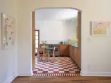 The kitchen features a checkerboard cement-tile floor, green countertops, and integrated appliances.