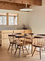 Several furnishings, including the red oak dining table, were built by Wes, who embraced George Nakashima’s philosophy that furniture should be used. “I mean, this table has been stabbed probably 30 million times by forks,” he says with a laugh.