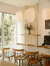 The living area doubles as a showroom for Isaac and Sydney’s new studio, Granada Form. A Slice table is surrounded by Boston chairs by Chilton, and behind them is a Peg shelving system. The Mori pendants are by RBW.