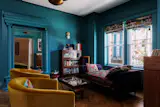 Theresa Mershon and Michelle Erfer brought their shared passion for color to the recent renovation of a 1910 town house in Queens, New York. Working with architect Luki Anderson of Studio Officina and color consultant Holly Faulkner, the couple employed a total of 17 shades in the 2,073-square-foot home, including Fruit Fool in the dining alcove and Vardo in the parlor. The velvet Tegan swivel chairs are from Interior Define. The Twin wall sconce is by Karen Gilbert for SkLO.