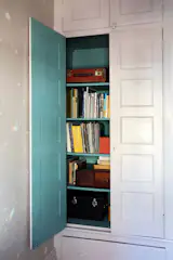 The smaller office features a wallpaper from Calico’s Prism collection. The inside of the closet is painted in Farrow & Ball’s Sugar Bag Light.