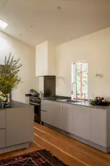 The kitchen sink is welded into the countertop and level with the windowsill, which creates a sense of unity, says Campbell.