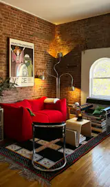 I found myself echoing red in my first apartment of my own via my Bambole sofa—placed atop an old rug of my dad’s.