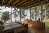Guest rooms, a wine cellar, and a flexible fitness space are located on the lower level.