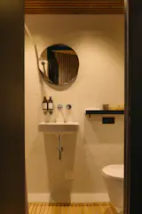 The bathroom is finished in iQ Optima, a Swedish vinyl. It’s from a collection that’s “inspired by the soft, translucent qualities of watercolor, creating a subtle sense of movement and depth,” Marius says.