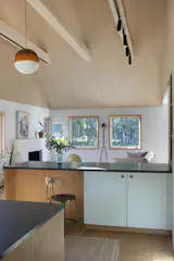 The cabinet faces are linoleum, another cost-effective choice and one of the few moments of color in the interior. “We work with a lot of whites and woods and let the materials speak for themselves,” Ruggieri says. “We try not to stain materials and leave them as real as possible so that it feels as grounding as possible.”