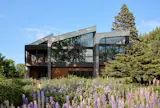 The 4,200-square-foot home, aptly named Crescendo, features lifted rooflines rising in sequence across the plan.