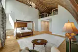 The primary bedroom suite has a 15-foot-long walk-in closet and a 20-foot vaulted ceiling open to the loft above.&nbsp;&nbsp;