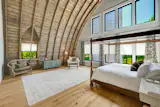 The barn’s original arched wood roof structure was left exposed, creating dramatic ceiling heights and adding texture throughout the interior.&nbsp;