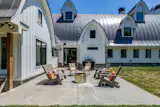 A patio with outdoor seating sits just off the kitchen, while the three-acre grounds leave room for a future pool.&nbsp;