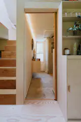 The bathroom is positined behind the stair and underneath one of the lofted sleeping area.