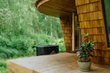 A ice bath from <a href="https://polaxtherapy.de/">Polax</a> sits near the deck off the sauna.