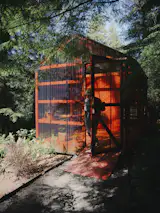 Downslope from the house, the couple built a 320-square-foot studio a shed (pictured here). The couple imposed two constraints on the project: a modest budget and the ability to do the work themselves while they lived in the house. âIn the end, the limitations forced a clarity that we probably wouldnât have arrived at otherwise,â says Alyson.