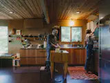In the kitchen, a cork floor joins a preexisting cedar ceiling and cherry plywood cabinets built by <a href="http://designinpractice.com/">Derek</a>.