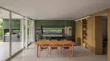Andy, who enjoys sailing, compares this wood cabinetry wall with sliding door panels (leading to a service area on one side and a media room on the other) to the efficiency of a boat. "I like that in boats, everything is very organized and not a single nook is wasted," he says. "This piece of built-in furniture has a bit of that spirit."