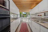 The galley kitchen has granite countertops and a breakfast nook with access to one of the home’s terraces.