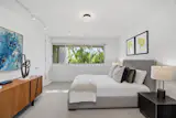 A guest bedroom on the lower level has access to a hallway bath, private entrance, and deck.