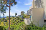 The hillside setting gives the home long views across Los Angeles and out toward the ocean.