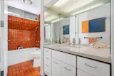 The home has three bathrooms, with two on the upper level and one downstairs.