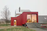 Zuzana Fuhrmannova and Tomas Binder bought a cabin they had been renting and expanded it with a red addition, designed and constructed by Facha Architekti.