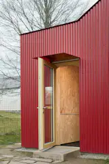 The new entrance includes cabinetry for storage.