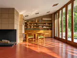Original elements remain throughout the house, including built-ins, cabinetry, light fixtures, perforated concrete block, mahogany millwork, and Wright-designed furniture.