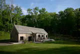 New York City–based GRT Architects designed this 1,500-square-foot, cedar-shingled house in Millbrook, New York for a young family who were living in a Brooklyn one-bedroom before moving upstate. 