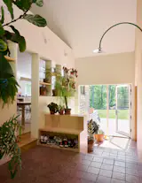 The floor is made of terra-cotta-hued cement tiles. The green arched sconce is by <a href="https://www.smallable.com/en/product/hanging-lamp-no.-2-mini-wall-sconce-muller-van-severen-green-valerie-objects-438180?country=US&amp;currency=USD&amp;utm_source=google&amp;utm_medium=cpc&amp;utm_campaign=1.+Pmax+DSG+US&amp;gad_source=1&amp;gad_campaignid=23828700940&amp;gbraid=0AAAAADxrY8u1msAn1fBYBlkd2Qvq1eQpx&amp;gclid=Cj0KCQjwt9jVBhDXARIsAFSP-6eLrjoACzVBo-jULc2s6unstqs0pODQW266o-gWffP4a31j7XSavlUaAotPEALw_wcB">Muller van Severen</a>.