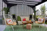 The pergola was made by SilverLining Inc. for the event, and is covered by fabric from Donghia. The turf and landscaping was handled by Evan C. Lai Landscape Design.