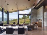 Floor-to-ceiling windows unveil a view of the stunning exterior scenery.
