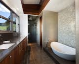 Redwood paneling is also seen in the master bathroom, complimenting the cool-toned mosaic tiles. 