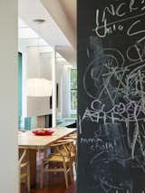 A chalkboard wall adds playfulness to the communal kitchen area. 