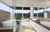 A stunning bathroom opens onto a patio for striking canyon views. 