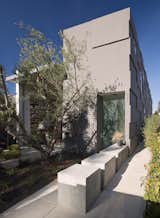 A single linear bar traverses the entire home along the property line and strings the interior spaces together, never breaking.  It begins at the exterior entrance as a concrete partition running perpendicular to the front door.  