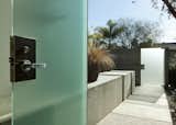 An additional view of the linear concrete partition shows it continuing inside the front door.