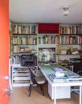 The space holds a library of book and a work table for two.  Photo 3 of 11 in Rebooting One Kansas House at a Time